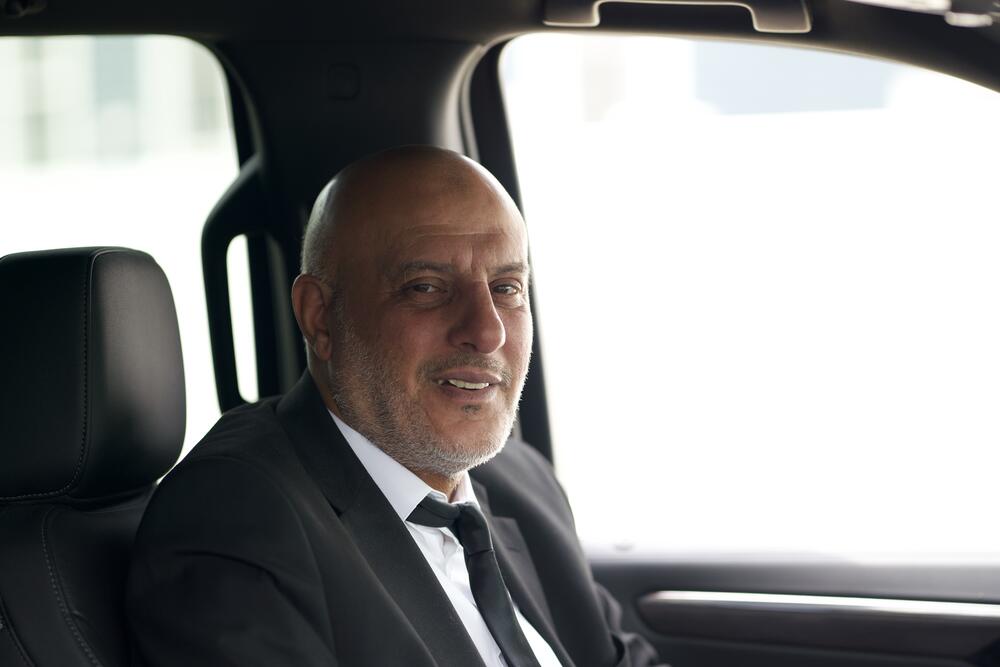 Smiling Cambridge Black Limo chauffeur behind the wheel